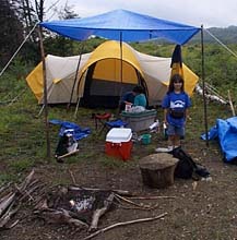 Rayna at camp with tent and tarp